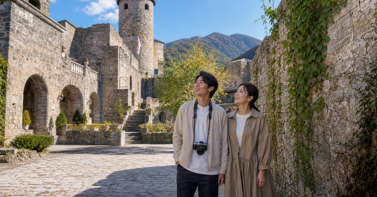 洋服姿のカップルが山あいの石造りの城を巡る利用イメージ