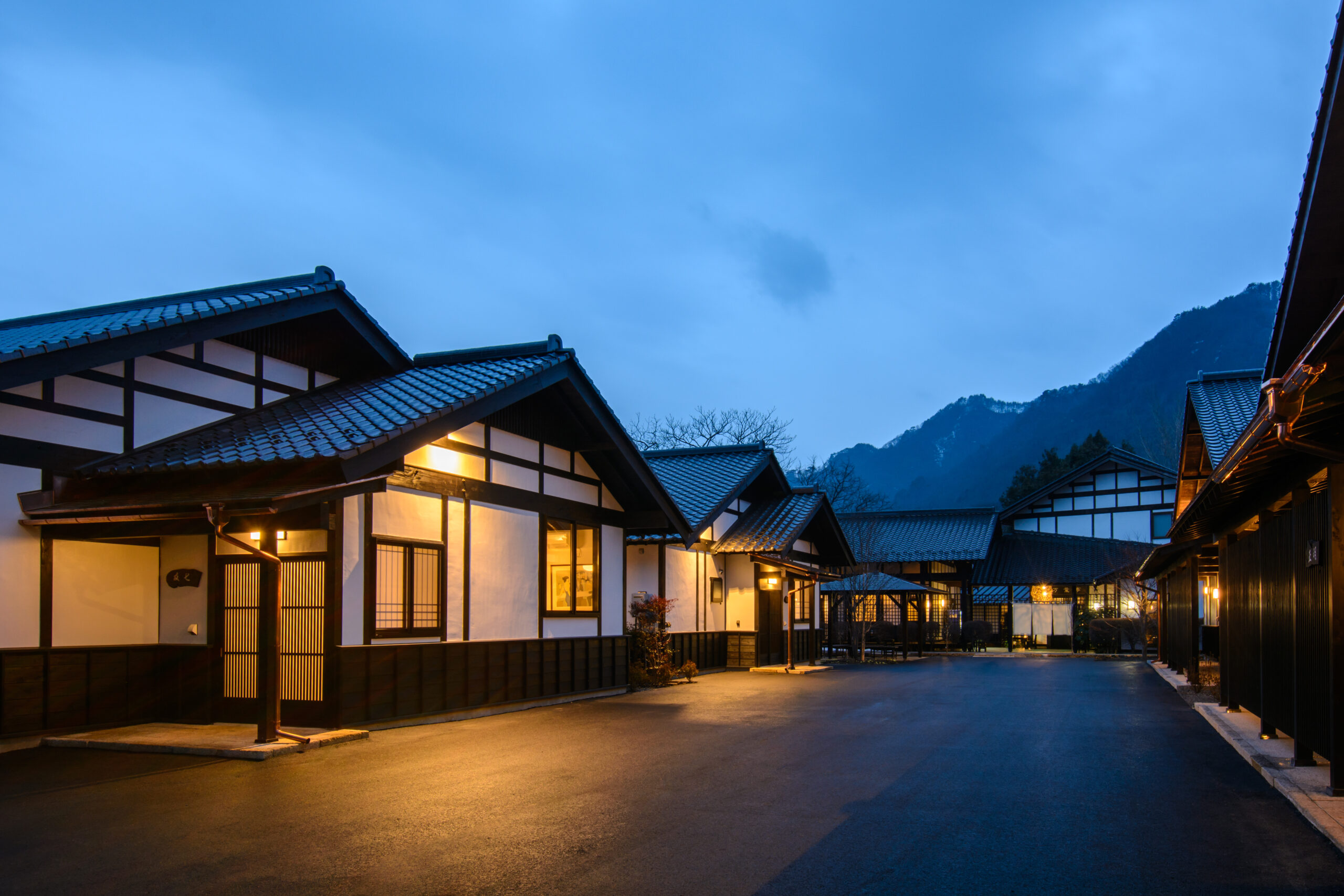 夕暮れに灯りがともる猿ヶ京温泉の旅籠屋丸一